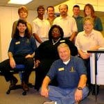 Technology Services staff in 2000: back row, l. to r.: Kathy Cole, assistant director of distance learning,; Barbara Cooper, computer support specialist; Eric Jones, telecommunications technician; Greg Heuberger, director of technology services; Gary Hickson, network administration; Pam Burton; applications programmer. Seated, l. to r.: Joseph Haney, student lab coordinator; Doris Malone, assistant director of systems; Cindy Young, applications programmer/webmaster. In front: Jim McCollum, computer technician (Click photo to enlarge)
