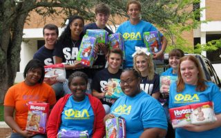 SAU PBL members pose with diapers collected during the Every Little Bottoms Diaper Drive.