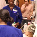 A theatre student, right, gives voice to a "patient" during an exercise to help prepare nursing students for hospital experiences.