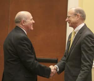 Dr. Trey Berry, left, shakes hands with current SAU President Dr. David Rankin.